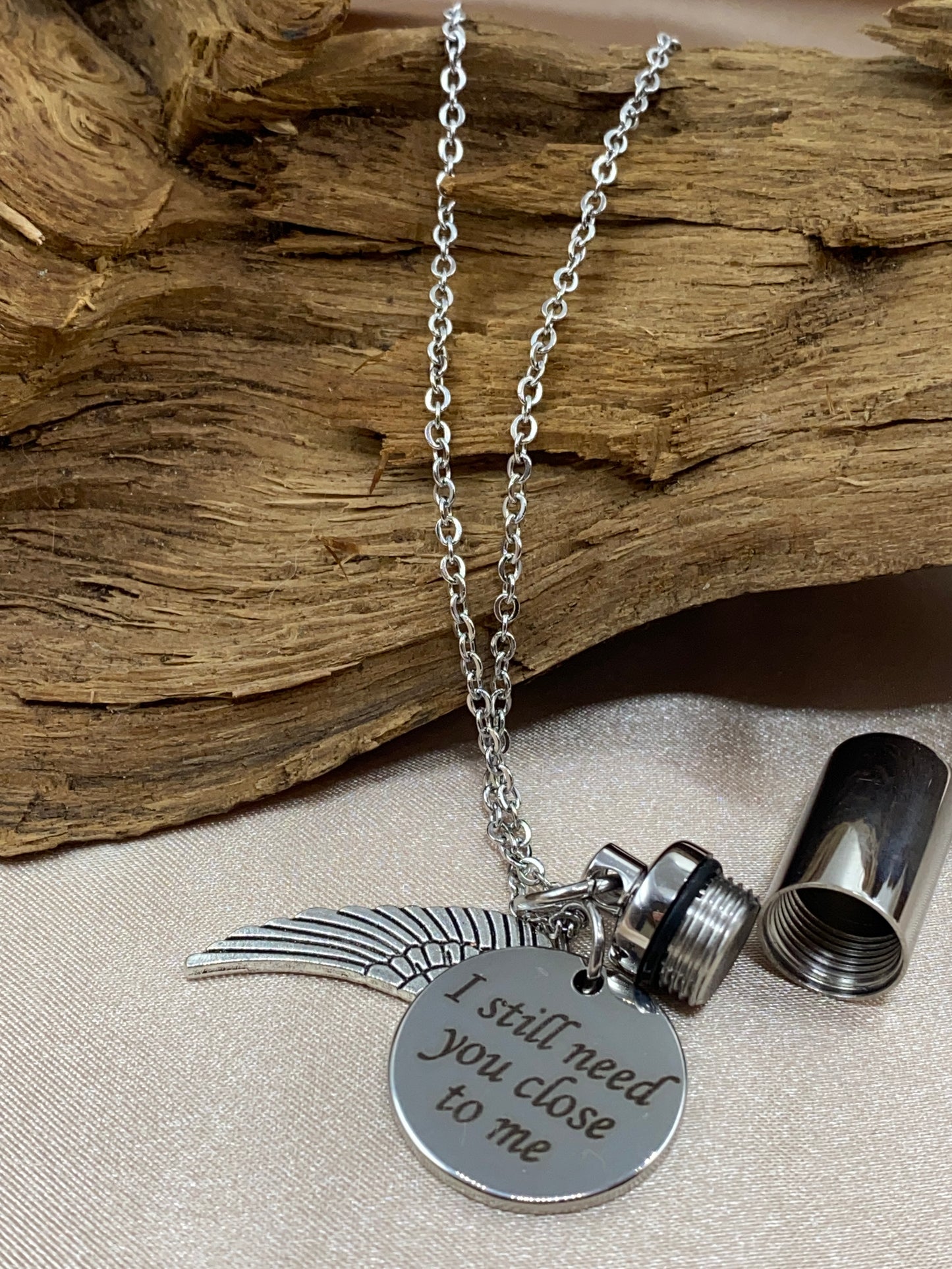 Cylinder pendant necklace with inspirational charm and angel wing charm