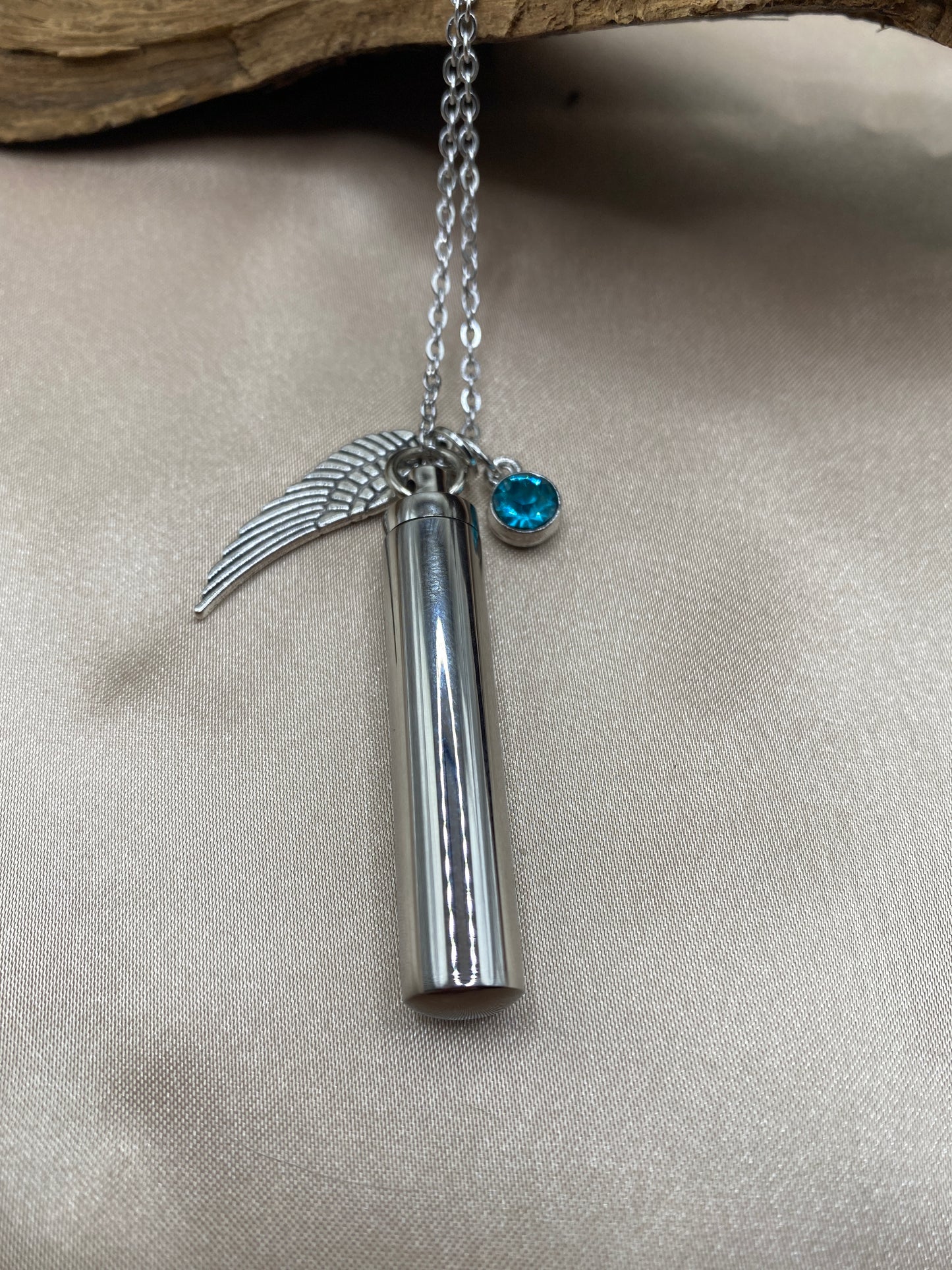 Cylinder cremation necklace with Angel wing charm and ocean blue stone
