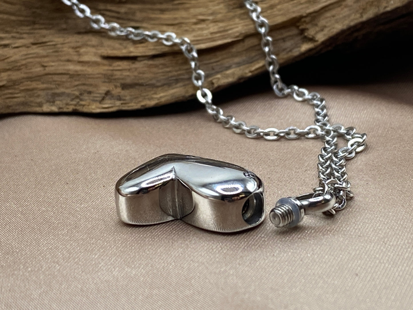 Stainless steel heart holds human and pet ashes
