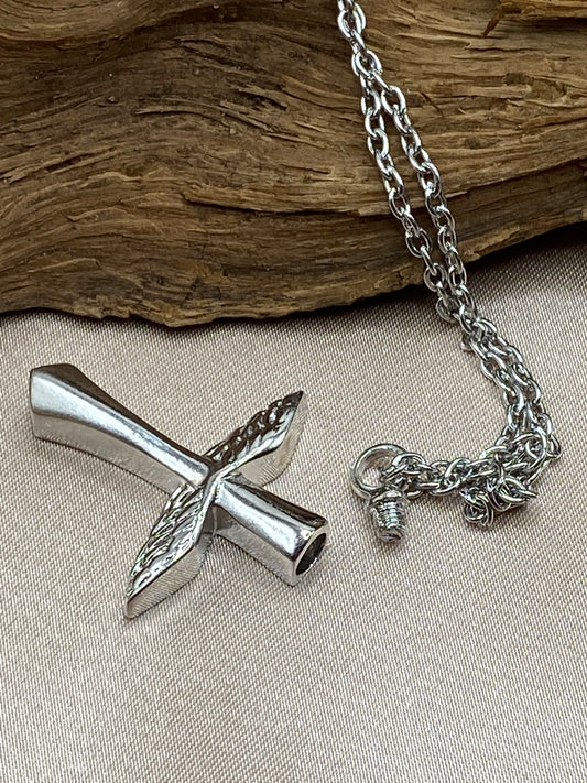 Cross cremation pendant opens to hold ashes