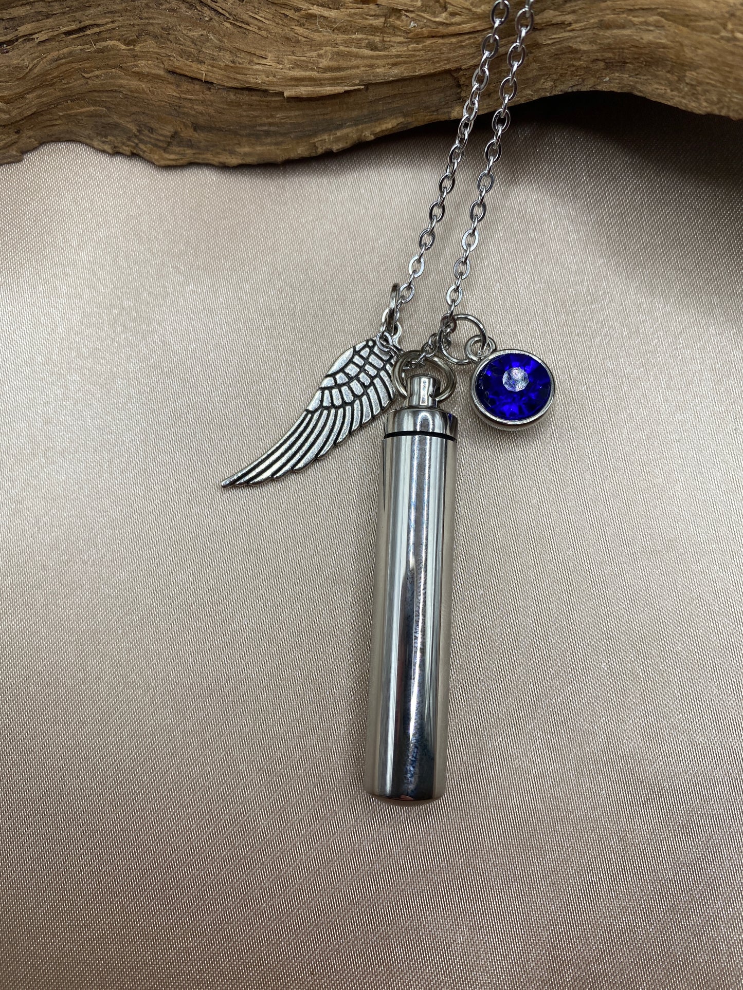 Cylinder cremation necklace with Angel wing charm and Ocean Blue stone