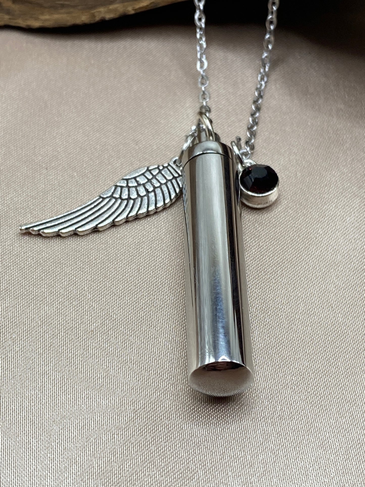 Cylinder cremation necklace with Angel wing charm and burgundy stone