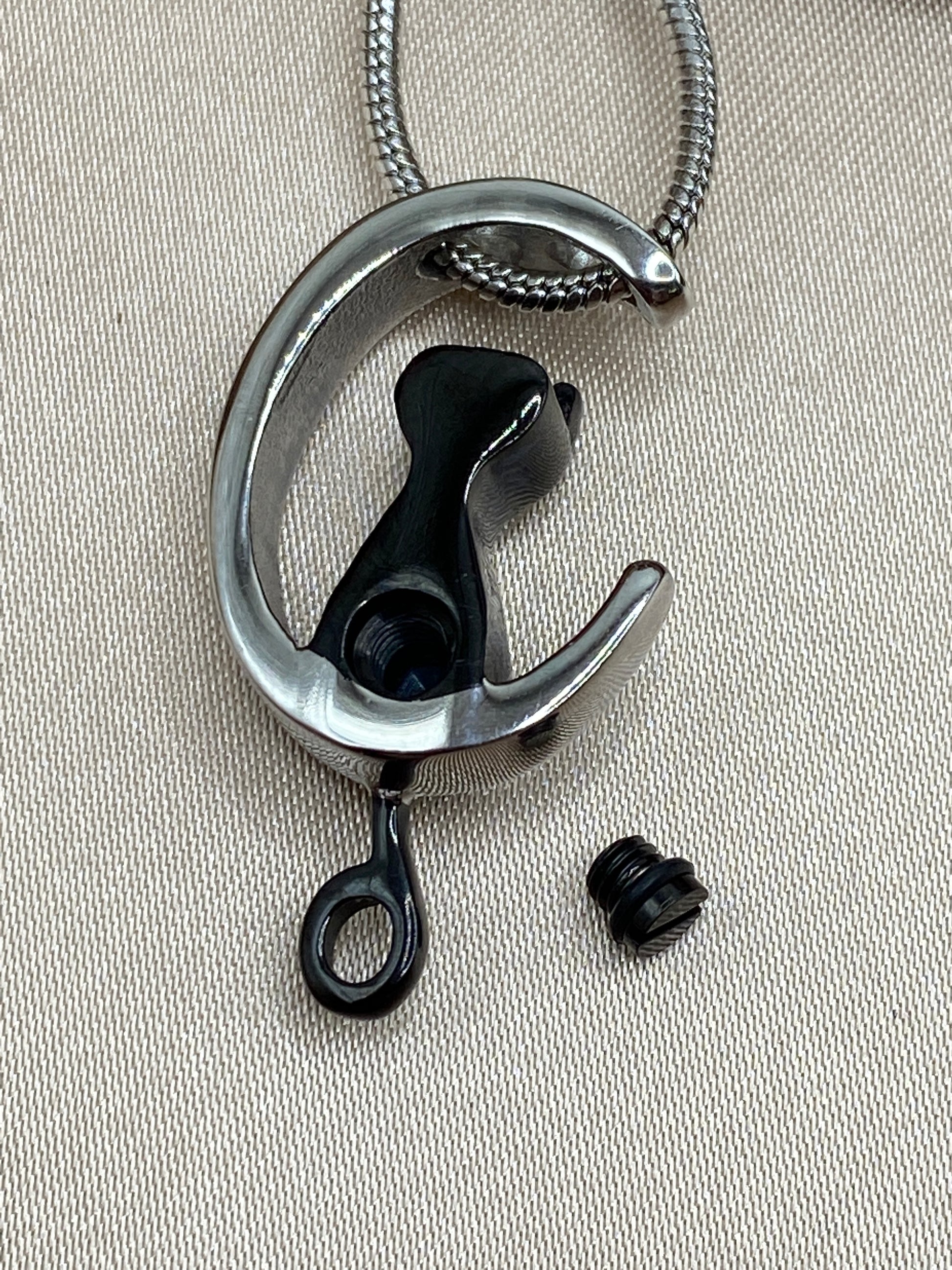 Openable cremation pendant holds pet ashes