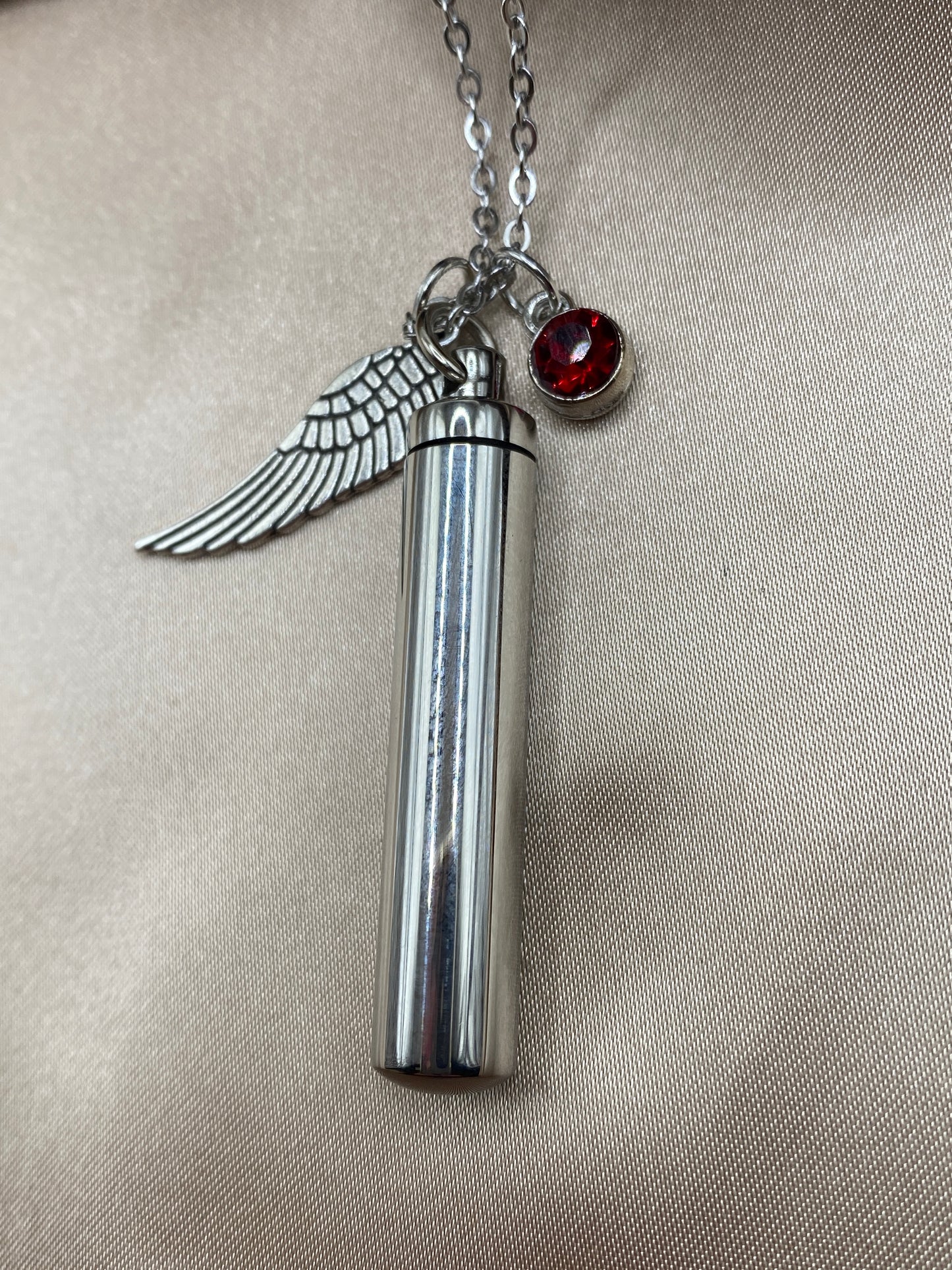 Cylinder cremation necklace with Angel wing charm and red rose stone