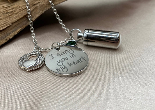 Small Silver Cylinder Cremation Urn Necklace with Angel Wing Charm - Personalized Memorial Jewelry to Hold Human or Pet Ashes, with an Inspirational Charm that Says 'I Carry You With Me