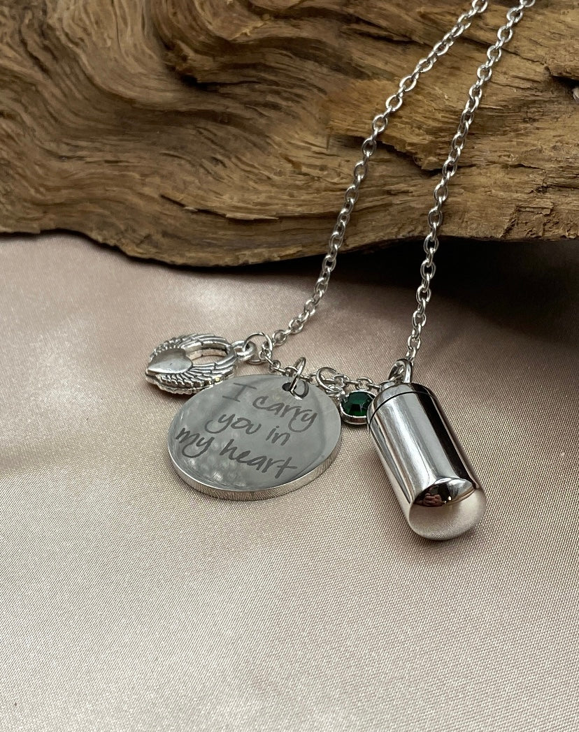 Small Silver Cylinder Cremation Urn Necklace with Angel Wing Charm - Personalized Memorial Jewelry to Hold Human or Pet Ashes, with an Inspirational Charm that Says 'I Carry You With Me