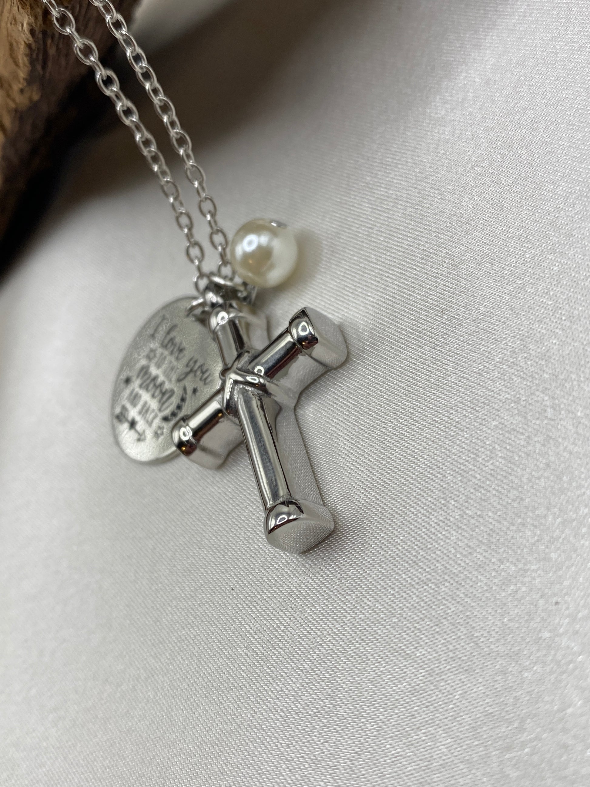 Cremation cross with charms for ashes