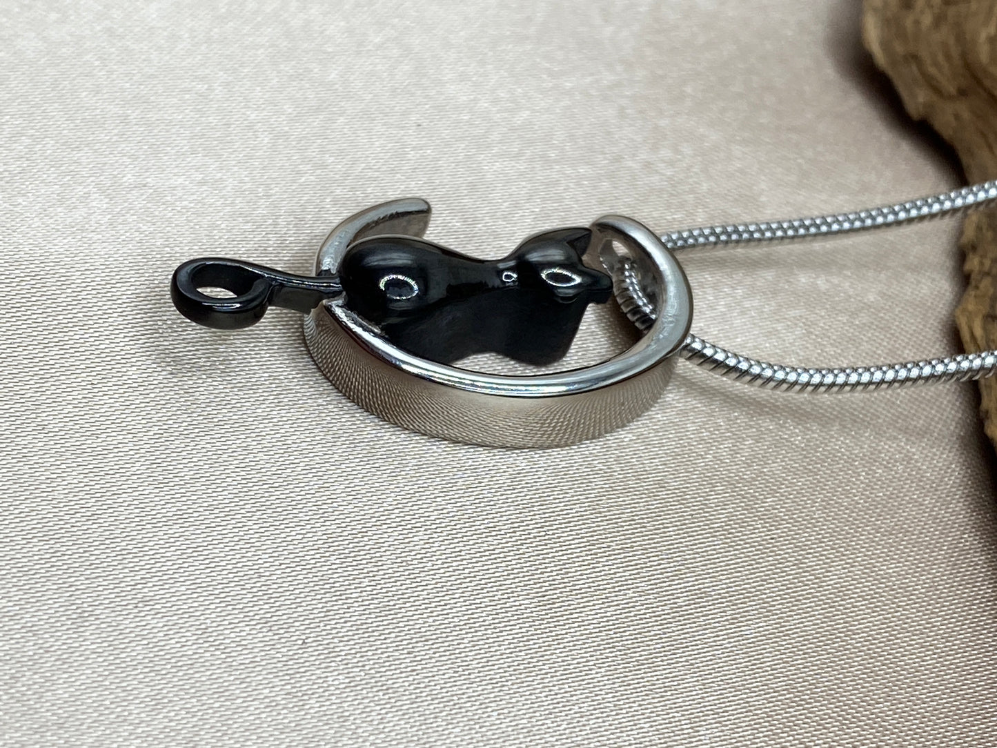 Black stainless steel cat with silver stainless steel moon